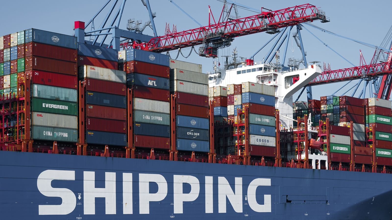 Container ship under port cranes