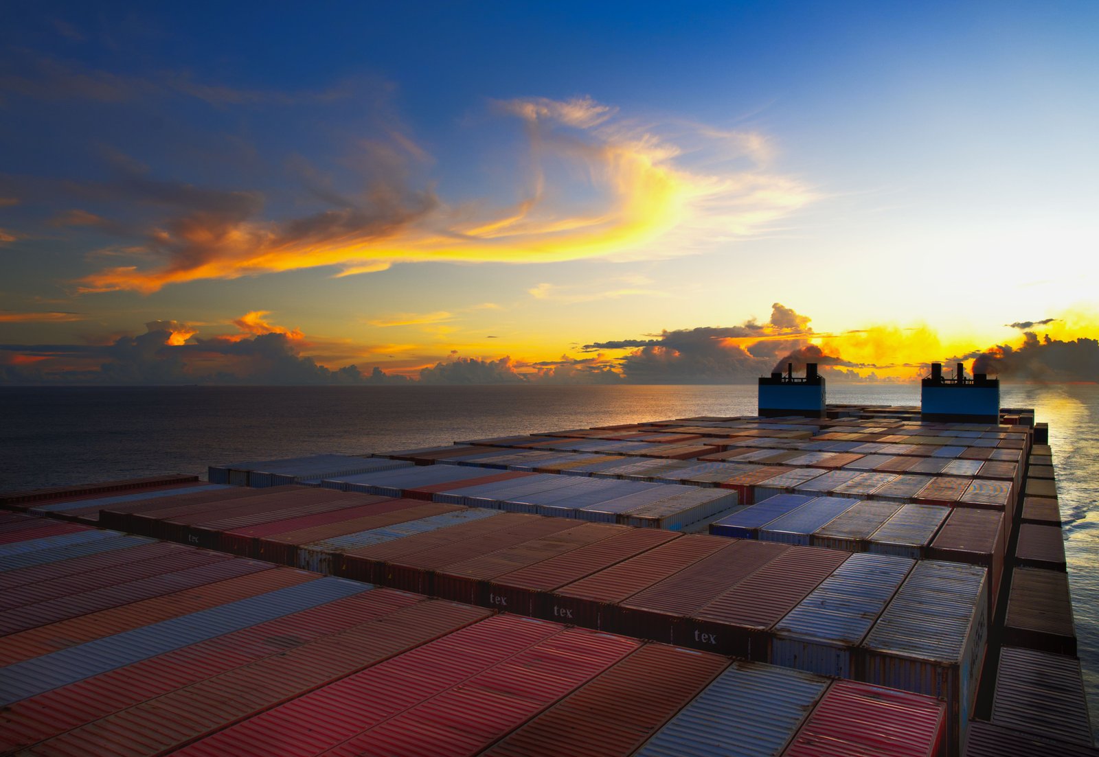 Container ship carrying export cargo at sea